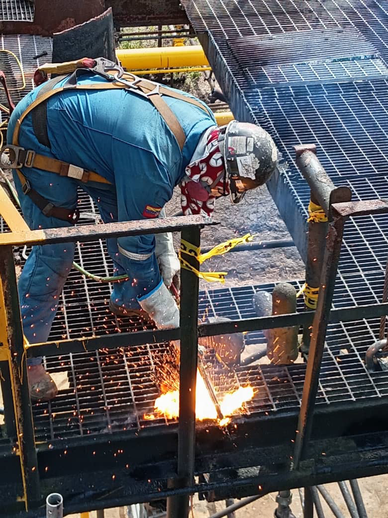 Worker welding on an operational structure