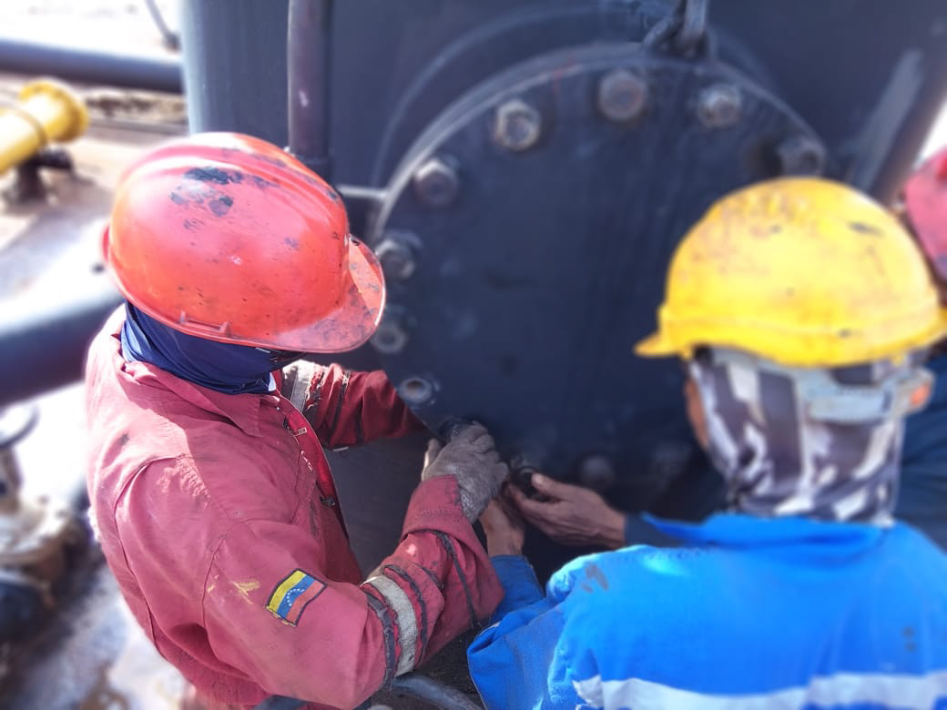 Technical team working on an industrial valve